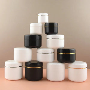 Lot of 30 refillable plastic cosmetic jars in white and black, with gold or silver bands, suitable for cream, lotion, mask, and travel samples.
